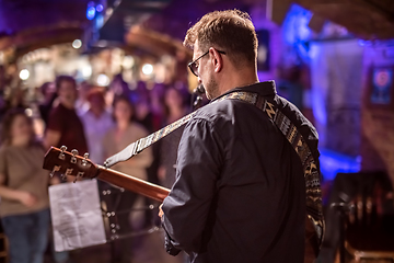 Image showing Band performs on stage, rock music concert.