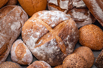 Image showing Freshly baked natural bread is on the kitchen table.