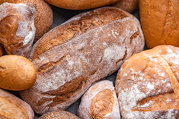 Image showing Freshly baked natural bread is on the kitchen table.