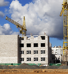 Image showing construction cranes and brick building