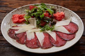 Image showing The carpaccio with cheese and salad top view