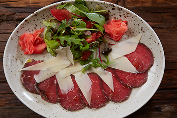 Image showing The carpaccio with cheese and salad top view
