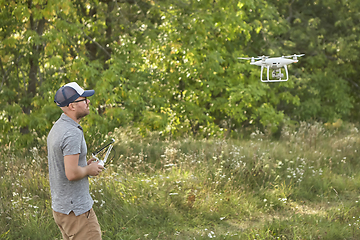 Image showing Man manages quadrocopters. Remote control for the drone in the hands of men. Unmanned aerial vehicle