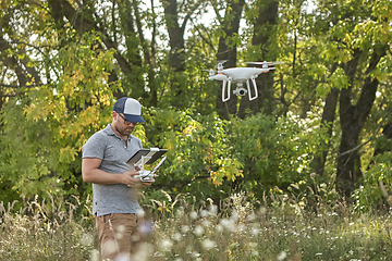 Image showing Man manages quadrocopters. Remote control for the drone in the hands of men. Unmanned aerial vehicle