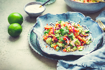 Image showing Healthy quinoa black bean salad with fresh tomatoes, cucumbers, onion and cilantro