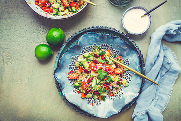 Image showing Healthy quinoa black bean salad with fresh tomatoes, cucumbers, onion and cilantro