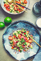 Image showing Healthy quinoa black bean salad with fresh tomatoes, cucumbers, onion and cilantro