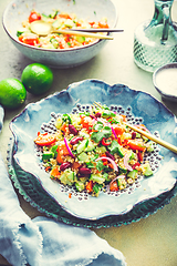 Image showing Healthy quinoa black bean salad with fresh tomatoes, cucumbers, onion and cilantro