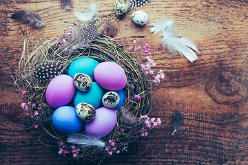 Image showing Happy Easter - nest with Easter eggs on wooden background with copy space