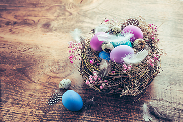 Image showing Happy Easter - nest with Easter eggs on wooden background with copy space