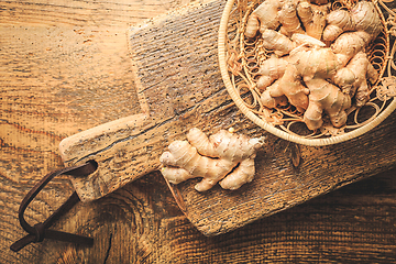 Image showing Fresh organic ginger roots on wooden background