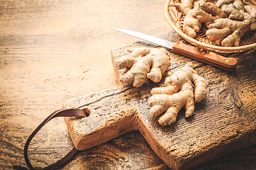 Image showing Fresh organic ginger roots on wooden background