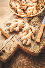 Image showing Fresh organic ginger roots on wooden background