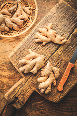 Image showing Fresh organic ginger roots on wooden background