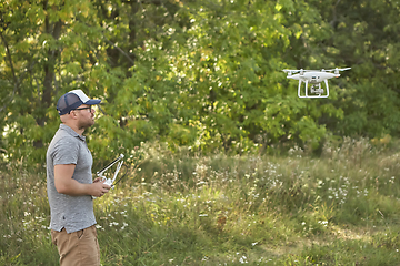 Image showing Man manages quadrocopters. Remote control for the drone in the hands of men. Unmanned aerial vehicle