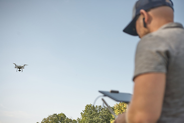 Image showing Man manages quadrocopters. Remote control for the drone in the hands of men. Unmanned aerial vehicle