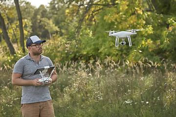 Image showing Man manages quadrocopters. Remote control for the drone in the hands of men. Unmanned aerial vehicle