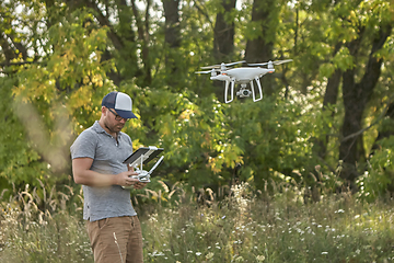 Image showing Man manages quadrocopters. Remote control for the drone in the hands of men. Unmanned aerial vehicle