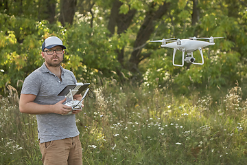 Image showing Man manages quadrocopters. Remote control for the drone in the hands of men. Unmanned aerial vehicle