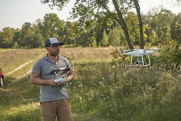 Image showing Man manages quadrocopters. Remote control for the drone in the hands of men. Unmanned aerial vehicle