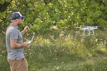 Image showing Man manages quadrocopters. Remote control for the drone in the hands of men. Unmanned aerial vehicle