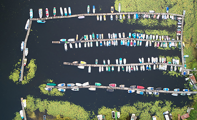 Image showing Top view of pier, Many speedboats and yachts in pier. Captured by drone