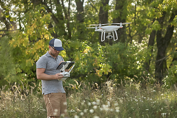 Image showing Man manages quadrocopters. Remote control for the drone in the hands of men. Unmanned aerial vehicle