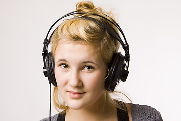 Image showing Young woman listening to music