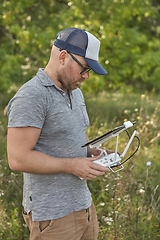 Image showing Man manages quadrocopters. Remote control for the drone in the hands of men. Unmanned aerial vehicle