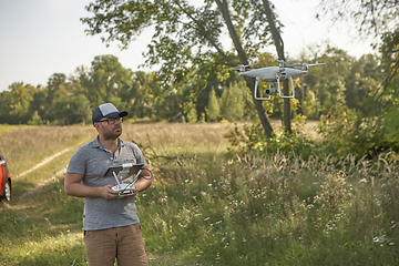 Image showing Man manages quadrocopters. Remote control for the drone in the hands of men. Unmanned aerial vehicle