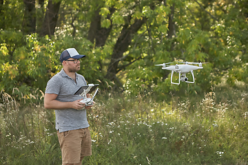 Image showing Man manages quadrocopters. Remote control for the drone in the hands of men. Unmanned aerial vehicle