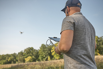 Image showing Man manages quadrocopters. Remote control for the drone in the hands of men. Unmanned aerial vehicle