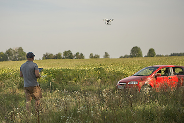 Image showing Man manages quadrocopters. Remote control for the drone in the hands of men. Unmanned aerial vehicle