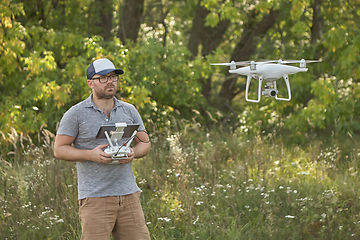 Image showing Man manages quadrocopters. Remote control for the drone in the hands of men. Unmanned aerial vehicle