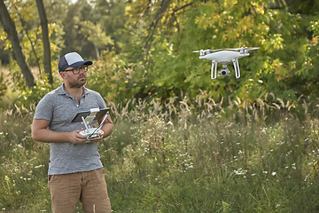 Image showing Man manages quadrocopters. Remote control for the drone in the hands of men. Unmanned aerial vehicle