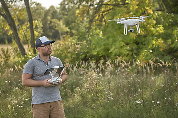 Image showing Man manages quadrocopters. Remote control for the drone in the hands of men. Unmanned aerial vehicle