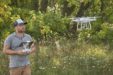 Image showing Man manages quadrocopters. Remote control for the drone in the hands of men. Unmanned aerial vehicle