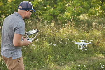 Image showing Man manages quadrocopters. Remote control for the drone in the hands of men. Unmanned aerial vehicle