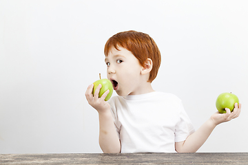 Image showing boy holds green apple