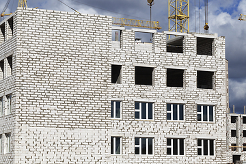 Image showing construction cranes and brick building