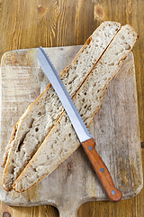 Image showing knife cutting cut dish bread