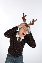 Image showing Young man wearing deer horns