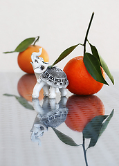 Image showing Tangerines and toy elephant 