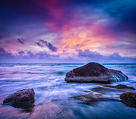 Image showing Waves and rocks on beach of sunset