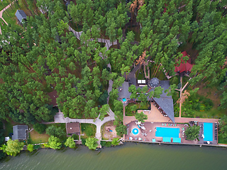 Image showing Aerial view of luxury house garden with swimming pool surrounded by trees.