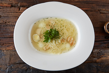 Image showing Chicken soup with noodles and vegetables in white bowl