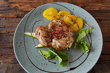 Image showing Chicken Steak with oranges and greens. Shallow dof.