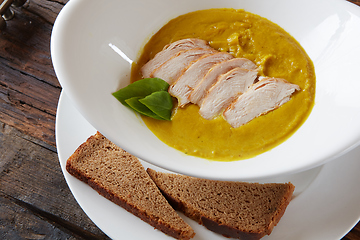 Image showing Pumpkin and carrot soup with chicken. Top view. Copy space.