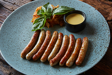 Image showing The grilled sausages in plate. Top view.