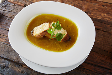 Image showing Onion soup in the ceramic pot. Shallow dof.